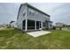 Two-story home with gray siding, a screened porch, and a concrete patio at 1528 Goldfinch Perch Ln, Knightdale, NC 27545