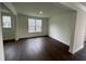 A light filled room with dark wood floors, white walls, trim, and natural light at 1528 Goldfinch Perch Ln, Knightdale, NC 27545