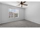 Neutral bedroom featuring a ceiling fan and window with blinds at 3 Cheltenham Dr, Clayton, NC 27520
