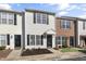 Two-story townhome with light-colored siding, brick accents, and a welcoming front porch at 3 Cheltenham Dr, Clayton, NC 27520