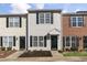 Charming townhouse with gray siding, black shutters, well-maintained landscaping and a front yard at 3 Cheltenham Dr, Clayton, NC 27520