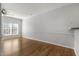 Bright living room with hardwood floors, large windows, and neutral paint at 3 Cheltenham Dr, Clayton, NC 27520