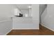View of an open concept living room with hardwood floors, a granite counter, and stairs at 3 Cheltenham Dr, Clayton, NC 27520