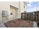 Fenced patio with brick pavers, white stone and a door leading into the home at 3 Cheltenham Dr, Clayton, NC 27520