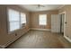 Simple bedroom with two windows, ceiling fan and access to another room at 308 Caswell St, Burlington, NC 27217