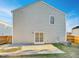 House's back with gray siding, sliding glass door, and a concrete patio at 3113 Skybrook Ln, Durham, NC 27703