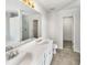 Bathroom with double vanity, a toilet and a large mirror at 3113 Skybrook Ln, Durham, NC 27703