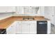 Kitchen features white cabinets, double sink and dishwasher at 3113 Skybrook Ln, Durham, NC 27703