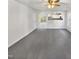 Open living room with gray carpeting and a view of the kitchen and backyard at 3113 Skybrook Ln, Durham, NC 27703