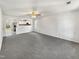 Open living room with gray carpeting and a view of the kitchen at 3113 Skybrook Ln, Durham, NC 27703