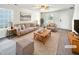 Virtually staged living room with beige couch and wooden coffee table at 3113 Skybrook Ln, Durham, NC 27703
