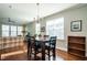 Bright dining area with wooden table and four chairs at 332 Dove Cottage Ln, Cary, NC 27519