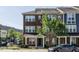 Three-story townhome with brick facade and landscaping at 332 Dove Cottage Ln, Cary, NC 27519