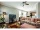 Living room with plaid couch and ottoman, open floor plan at 332 Dove Cottage Ln, Cary, NC 27519