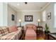 Living room with plaid sofa and chair, hardwood floor at 332 Dove Cottage Ln, Cary, NC 27519