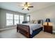 Spacious main bedroom with wooden bed frame and large windows at 332 Dove Cottage Ln, Cary, NC 27519