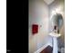 Small powder room with pedestal sink and round mirror at 332 Dove Cottage Ln, Cary, NC 27519
