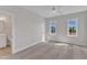 Spacious bedroom with two large windows offering abundant natural light and neutral carpet at 3803 Bennett Grove Dr, Wake Forest, NC 27587