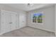 Bedroom with a window featuring two closets and neutral carpet at 3803 Bennett Grove Dr, Wake Forest, NC 27587