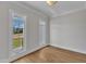 Bedroom with hardwood floors, neutral paint, large windows, and white trim at 3803 Bennett Grove Dr, Wake Forest, NC 27587