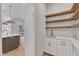 Stylish butler's pantry with white cabinets, open wood shelving, sink, and quartz countertops at 3803 Bennett Grove Dr, Wake Forest, NC 27587