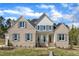 Beautiful brick home with gray shutters, white siding, manicured lawn, and elegant front entrance at 3803 Bennett Grove Dr, Wake Forest, NC 27587