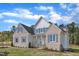 Beautiful home with light brick, gray shutters, white siding, and pristine lawn with fresh landscaping at 3803 Bennett Grove Dr, Wake Forest, NC 27587