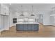 Elegant kitchen with island, pendant lighting, and stainless steel appliances at 3803 Bennett Grove Dr, Wake Forest, NC 27587