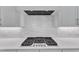 Modern kitchen with gas cooktop, white subway tile backsplash, and stainless steel vent hood at 3803 Bennett Grove Dr, Wake Forest, NC 27587