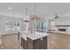Bright, open kitchen featuring a large island, farmhouse sink, and seamless flow to the living area and screened porch at 3803 Bennett Grove Dr, Wake Forest, NC 27587