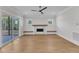 Bright living room featuring hardwood floors, a fireplace, and sliding door to the deck at 3803 Bennett Grove Dr, Wake Forest, NC 27587
