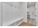 Well-organized mudroom featuring a built-in bench, storage cubbies, and adjacent laundry room at 3803 Bennett Grove Dr, Wake Forest, NC 27587