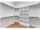 Bright walk-in closet with built-in shelving and wood flooring at 3803 Bennett Grove Dr, Wake Forest, NC 27587