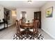 Bright dining room with wood table and chairs, hardwood floors, and kitchen view at 431 Oak Run Dr, Raleigh, NC 27606