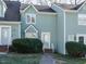 Front view of charming townhome with brick steps and well-manicured landscaping at 431 Oak Run Dr, Raleigh, NC 27606
