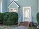 Front entrance of townhome featuring brick steps and green siding at 431 Oak Run Dr, Raleigh, NC 27606