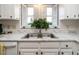 Kitchen features white cabinets, a marble countertop, and a double sink at 431 Oak Run Dr, Raleigh, NC 27606