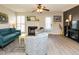 Living room boasts a fireplace, teal sofa, and ample natural light at 431 Oak Run Dr, Raleigh, NC 27606