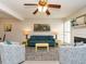 Open living room with a view into the dining area, featuring teal seating and a yellow coffee table at 431 Oak Run Dr, Raleigh, NC 27606