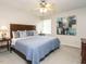Spacious main bedroom with a ceiling fan, large bed, and ensuite bathroom at 431 Oak Run Dr, Raleigh, NC 27606