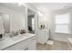 Clean bathroom with a single vanity, white cabinets and tiled floors at 438 S Hillsborough St, Franklinton, NC 27525
