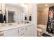 Modern bathroom with double vanity, bathtub, and shower at 438 S Hillsborough St, Franklinton, NC 27525