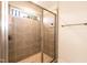 Walk-in shower with gray tiles and glass enclosure at 438 S Hillsborough St, Franklinton, NC 27525