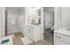 Modern bathroom with a single vanity, shower, and tiled floors at 438 S Hillsborough St, Franklinton, NC 27525