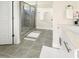 Large bathroom with a walk-in shower and gray tile flooring at 438 S Hillsborough St, Franklinton, NC 27525