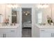 Double vanity bathroom with white cabinets and quartz countertops at 438 S Hillsborough St, Franklinton, NC 27525