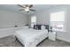 Cozy bedroom with a queen-size bed, two windows, and gray carpet at 438 S Hillsborough St, Franklinton, NC 27525