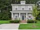 Two-story Craftsman home with gray siding, front porch, and landscaped lawn at 438 S Hillsborough St, Franklinton, NC 27525