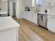 Modern kitchen with white cabinets, quartz countertops, and stainless steel appliances at 438 S Hillsborough St, Franklinton, NC 27525