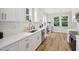 Modern kitchen with white cabinets, quartz countertops, and stainless steel appliances at 438 S Hillsborough St, Franklinton, NC 27525
